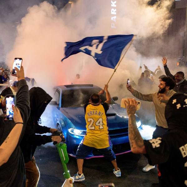 Fans celebrate on the streets after the Los Angeles Dodgers won against the New York Yankees in the baseball World Series Wednesday, Oct. 30, 2024, in downtown Los Angeles. (AP Photo/Damian Dovarganes)