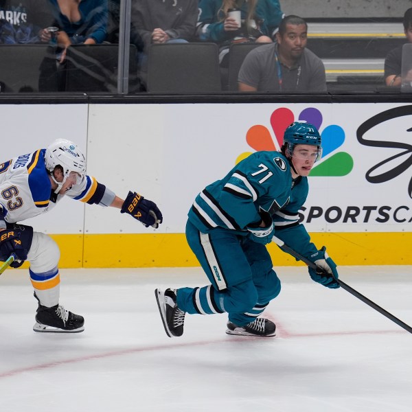 St. Louis Blues left wing Jake Neighbours, left, chases after San Jose Sharks center Macklin Celebrini, right, during the first period of an NHL hockey game Thursday, Oct. 10, 2024, in San Jose, Calif. (AP Photo/Godofredo A. Vásquez)