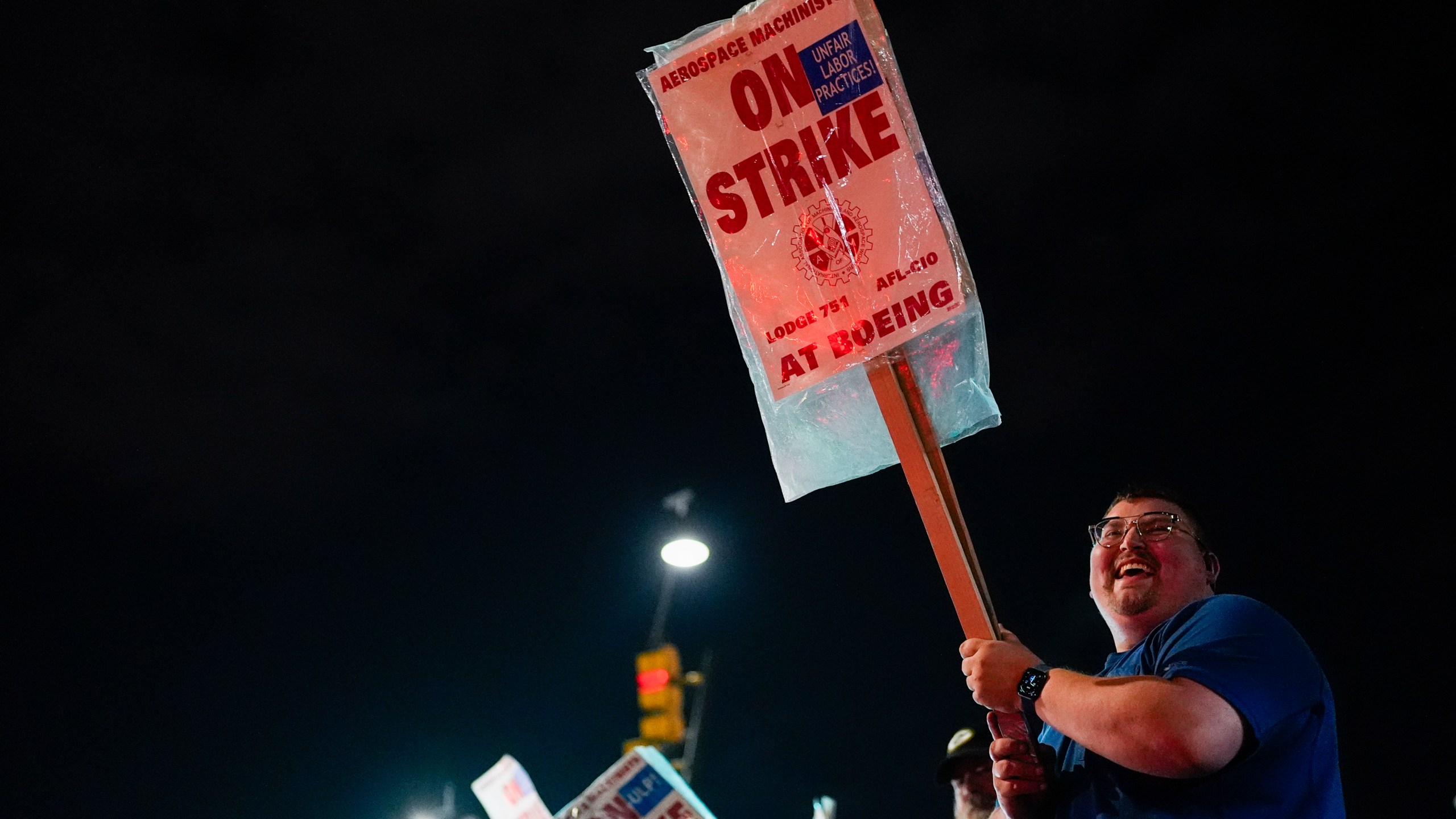 Machinist AJ Nelson, who has worked for Boeing for six years, works the picket line after union members voted to reject a new contract offer from the company, Wednesday, Oct. 23, 2024, in Renton, Wash. (AP Photo/Lindsey Wasson)