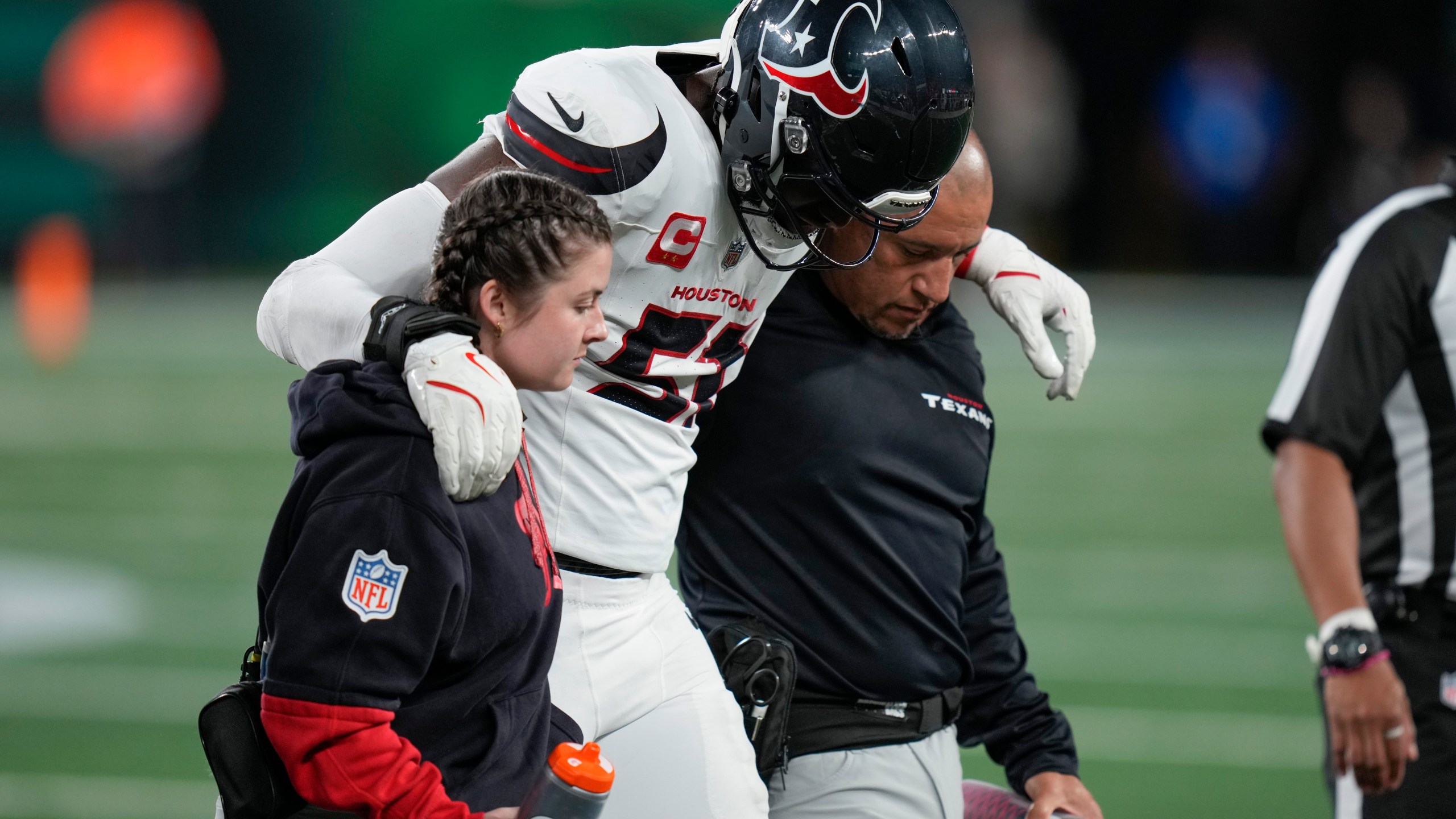 Houston Texans defensive end Will Anderson Jr. (51) is helped off the field after an injury during the first half an NFL football game against the New York Jets, Thursday, Oct. 31, 2024, in East Rutherford, N.J. (AP Photo/Seth Wenig)