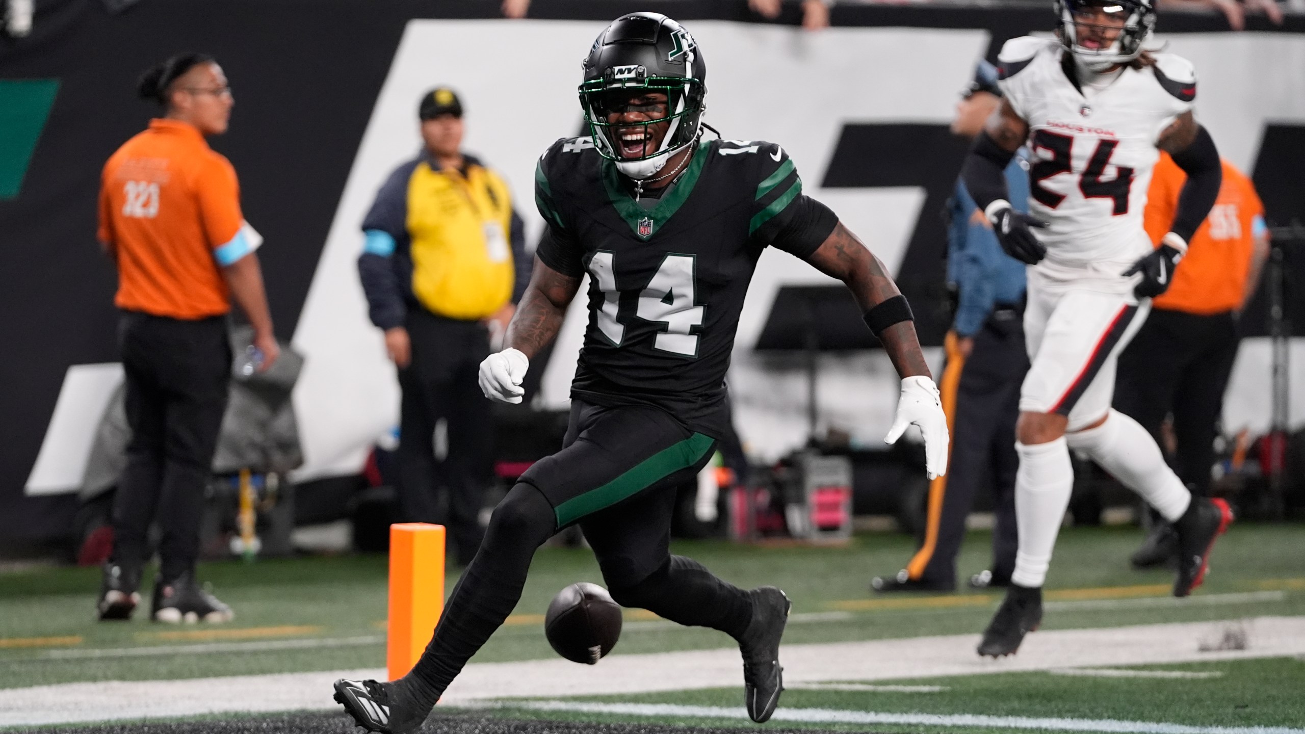 New York Jets wide receiver Malachi Corley (14) drops the ball before scoring a touchdown during the first half an NFL football game against the Houston Texans, Thursday, Oct. 31, 2024, in East Rutherford, N.J. (AP Photo/Frank Franklin II)