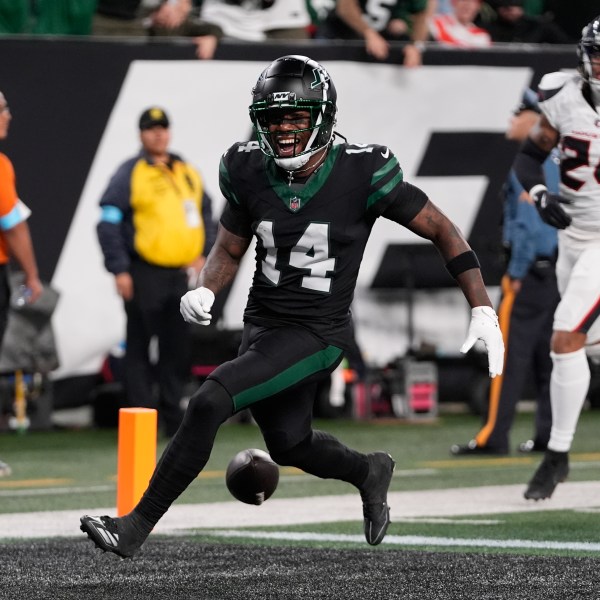 New York Jets wide receiver Malachi Corley (14) drops the ball before scoring a touchdown during the first half an NFL football game against the Houston Texans, Thursday, Oct. 31, 2024, in East Rutherford, N.J. (AP Photo/Frank Franklin II)