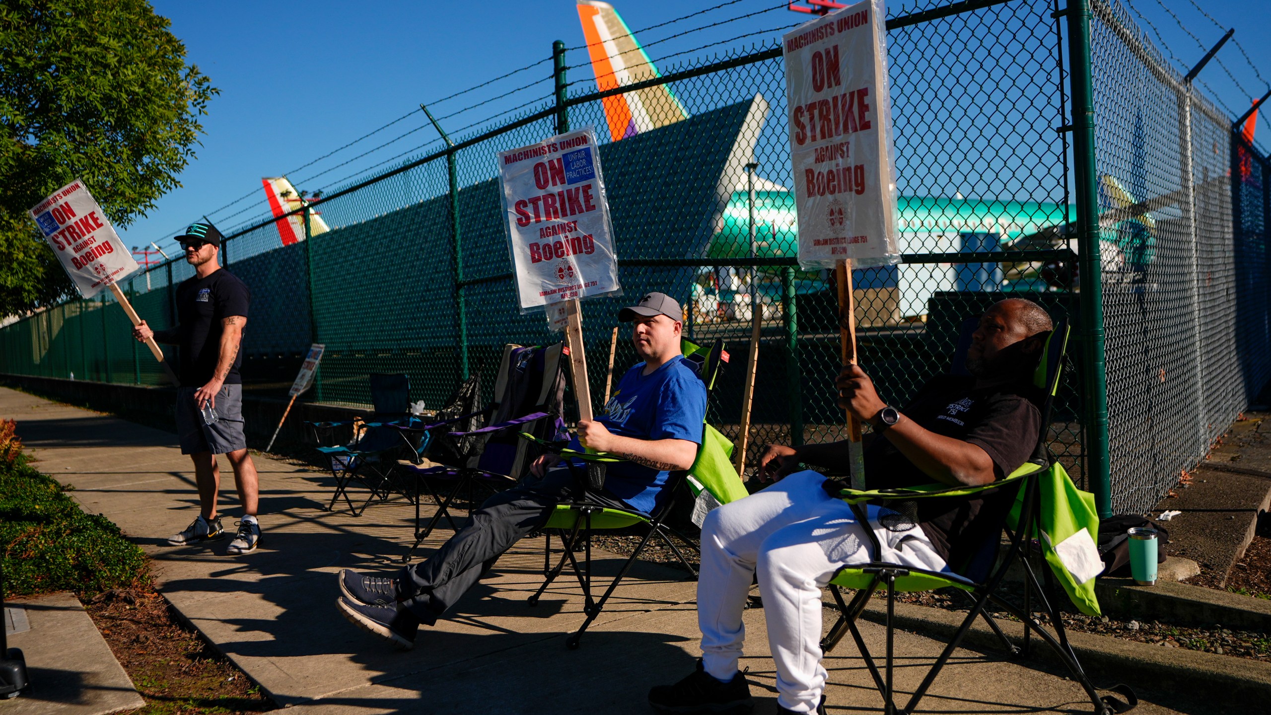 FILE - Boeing 737 Max aircrafts are seen behind fences as striking Boeing workers picket on Sept. 24, 2024, next to the company's facilities in Renton, Wash. (AP Photo/Lindsey Wasson, File)