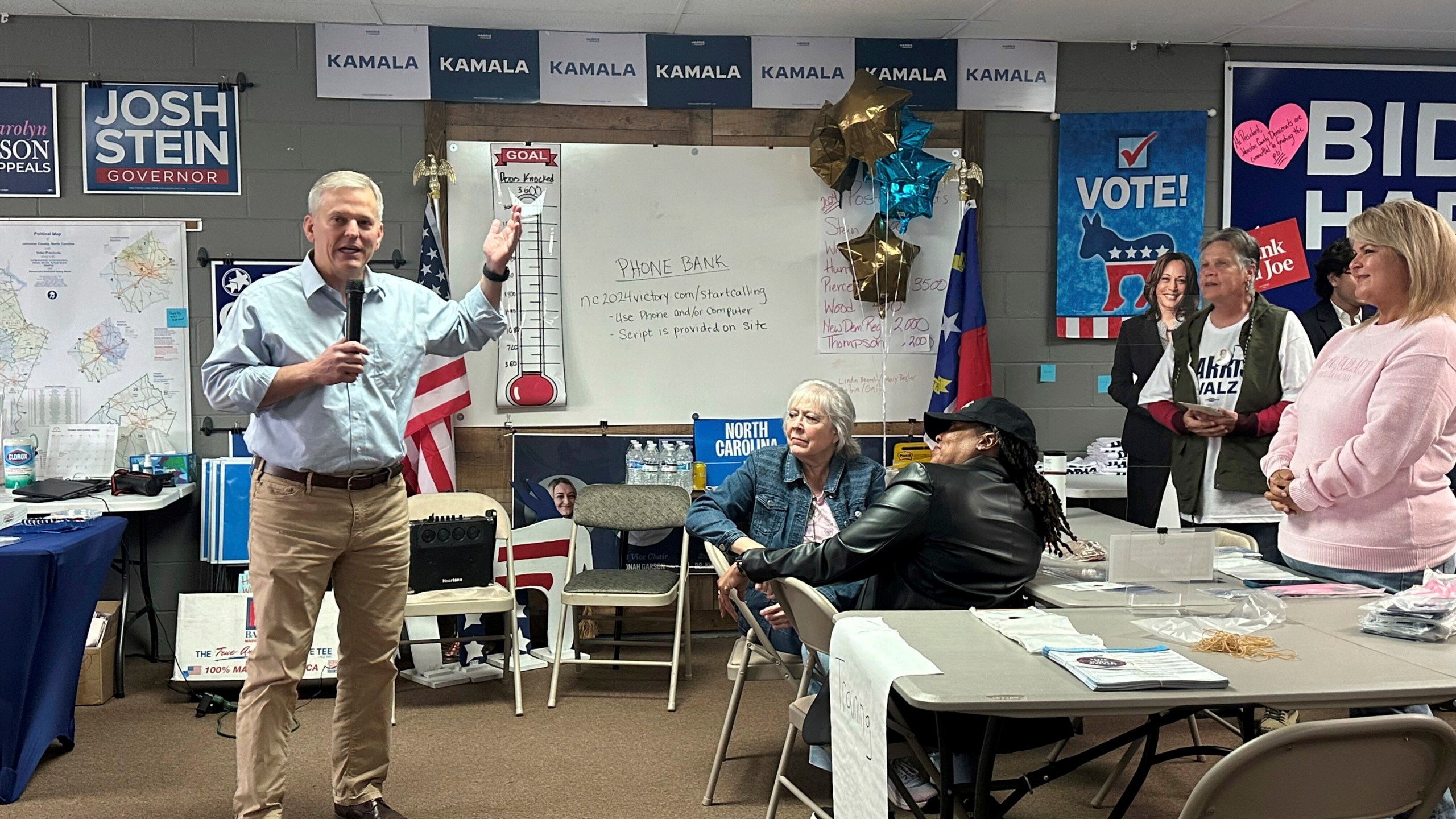 North Carolina Democratic gubernatorial nominee and state Attorney General Josh Stein, left, speaks to Johnston County Democratic Party volunteers Tuesday, Oct. 29, 2024, in Smithfield, N.C. (AP Photo/Gary D. Robertson)