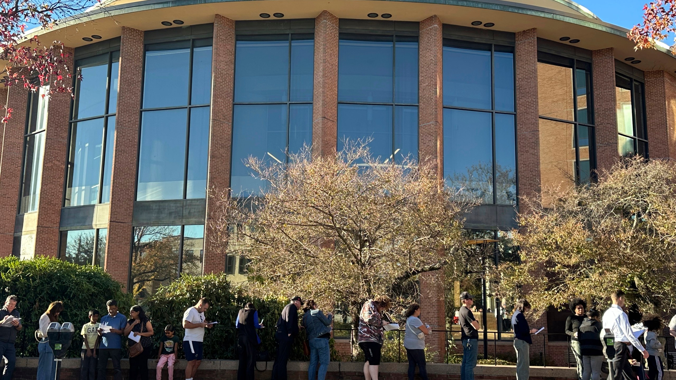 Voters line up outside the Bucks County Administration Building during early voting in the general election, Friday, Nov. 1, 2024, in Doylestown, Pa. (AP Photo/Michael Rubinkam)