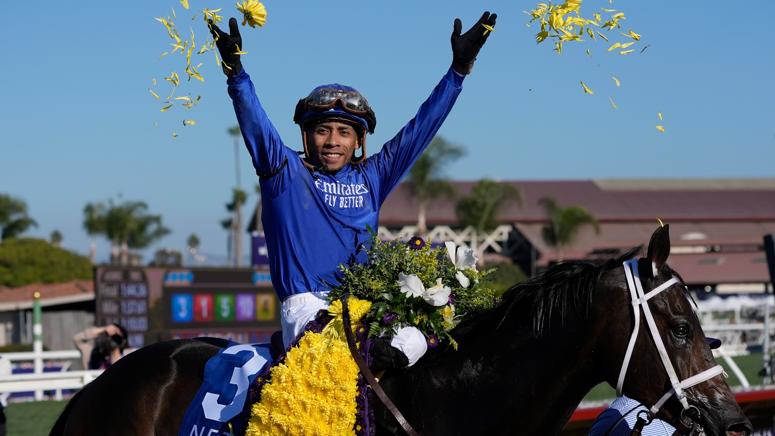 Manuel Franco celebrates after riding Immersive to victory in the Breeders' Cup Juvenile Fillies horse race at Santa Anita Park in Del Mar, Calif., Friday, Nov. 1, 2024. (AP Photo/Gregory Bull)