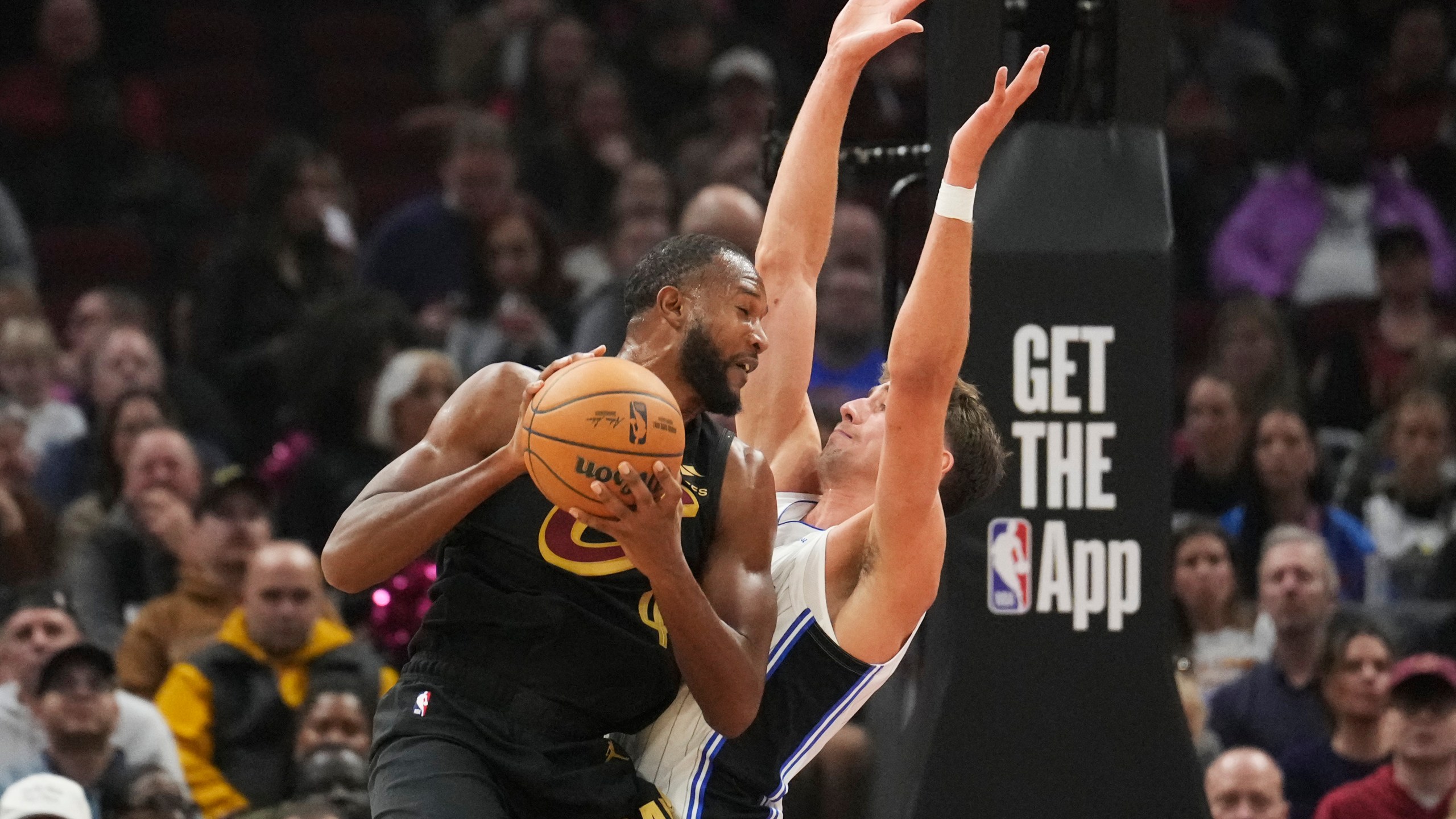 Cleveland Cavaliers forward Evan Mobley drives against Orlando Magic forward Franz Wagner, right, in the first half of an NBA game, Friday, Nov. 1, 2024, in Cleveland. (AP PhotoSue Ogrocki)