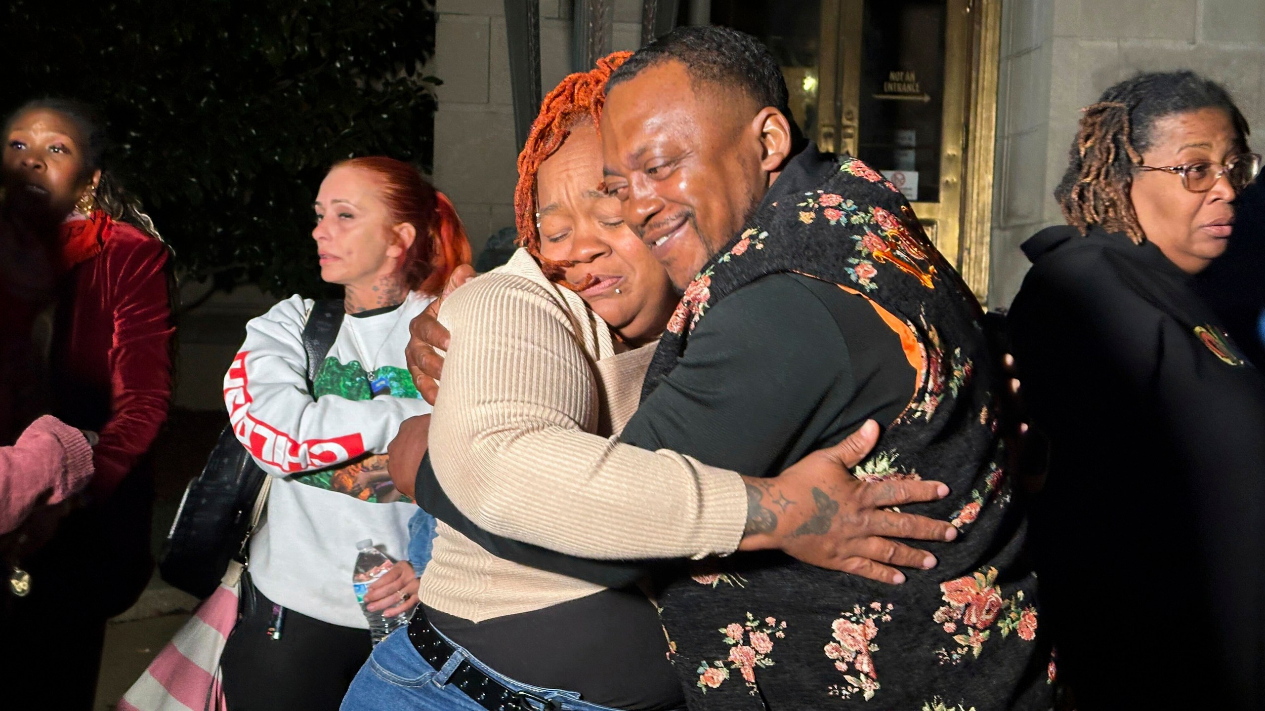 Breonna Taylor's mother, Tamika Palmer, center left, hugs a friend in Louisville, Ky., Friday, Nov. 1, 2024, after a former Kentucky police officer was convicted in federal court for using excessive force when he fired his gun during the deadly raid that left Taylor dead in 2020. (AP Photo/Dylan Lovan)