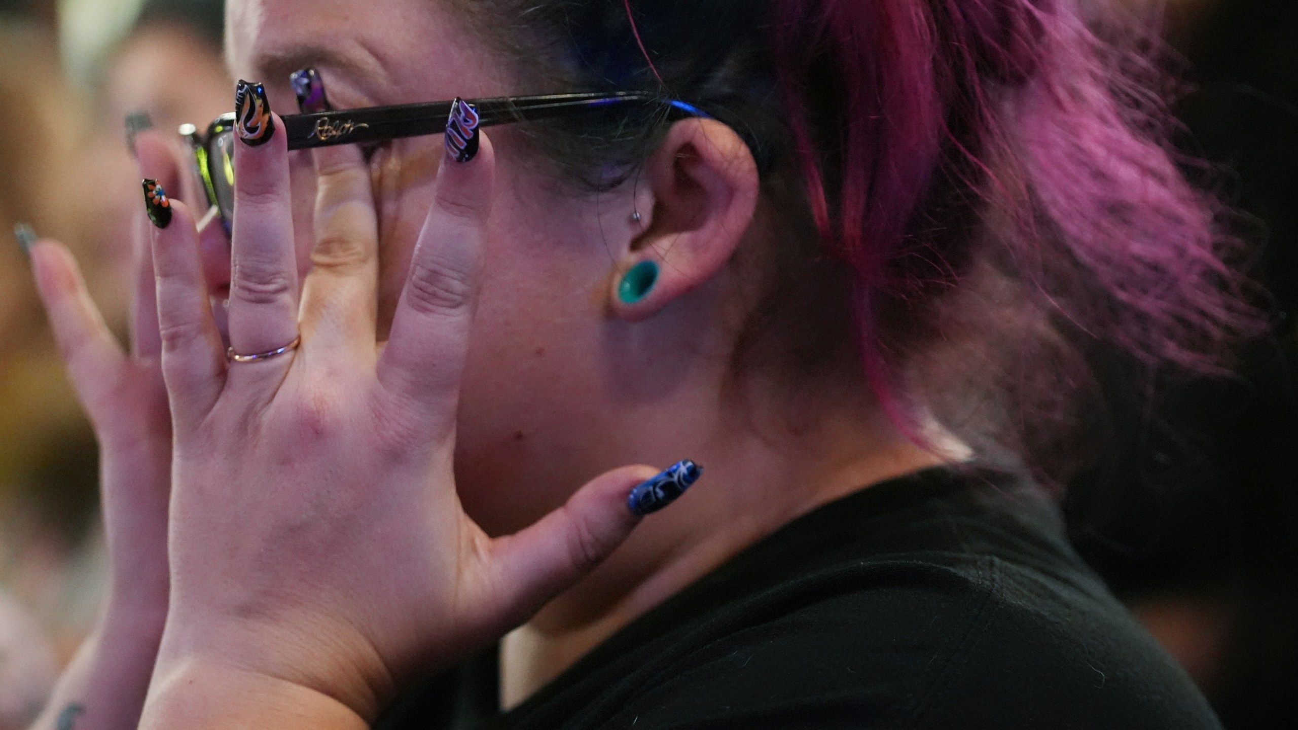 Emmie Reed, center, co-founder of Bans Off Our Bodies Florida collective, wipes away tears after Florida's Amendment 4, which would have enshrined abortion rights in the state, fell short of the 60% vote threshold required to pass, during a watch party for the Yes On 4 campaign, on Election Day, Tuesday, Nov. 5, 2024, in St. Petersburg, Fla. (AP Photo/Rebecca Blackwell)