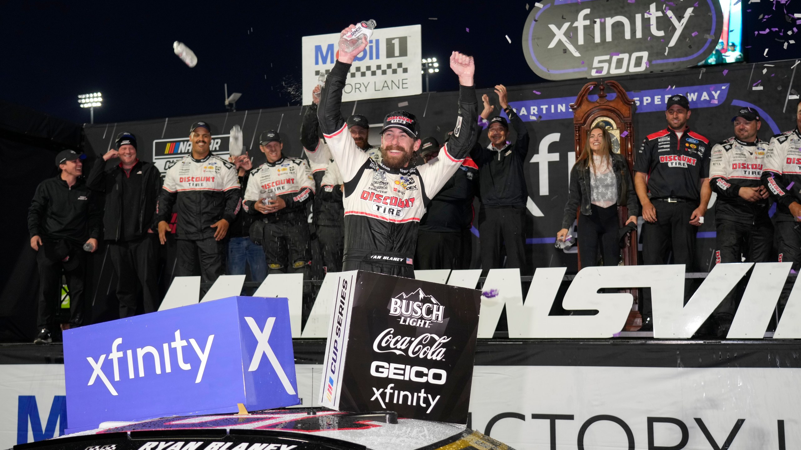 Ryan Blaney, center, celebrates in Victory Lane after winning a NASCAR Cup Series auto race at Martinsville Speedway in Martinsville, Va., Sunday, Nov. 3, 2024. (AP Photo/Chuck Burton)