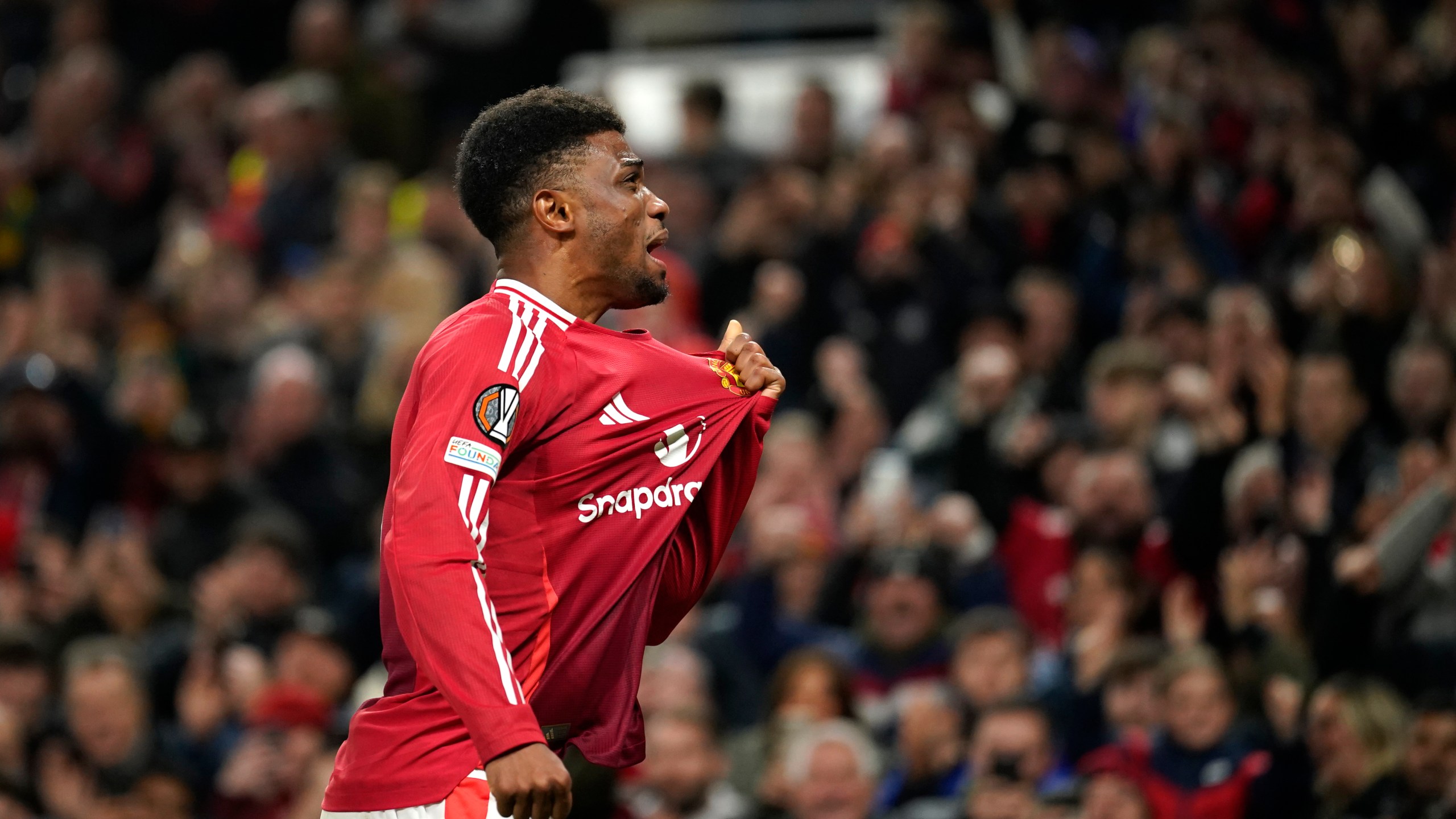 Manchester United's Amad Diallo celebrates after scoring his side's second goal during the Europa League opening phase soccer match between Manchester United and PAOK at the Old Trafford stadium in Manchester, England, Thursday, Nov. 7, 2024. (AP Photo/Dave Thompson)