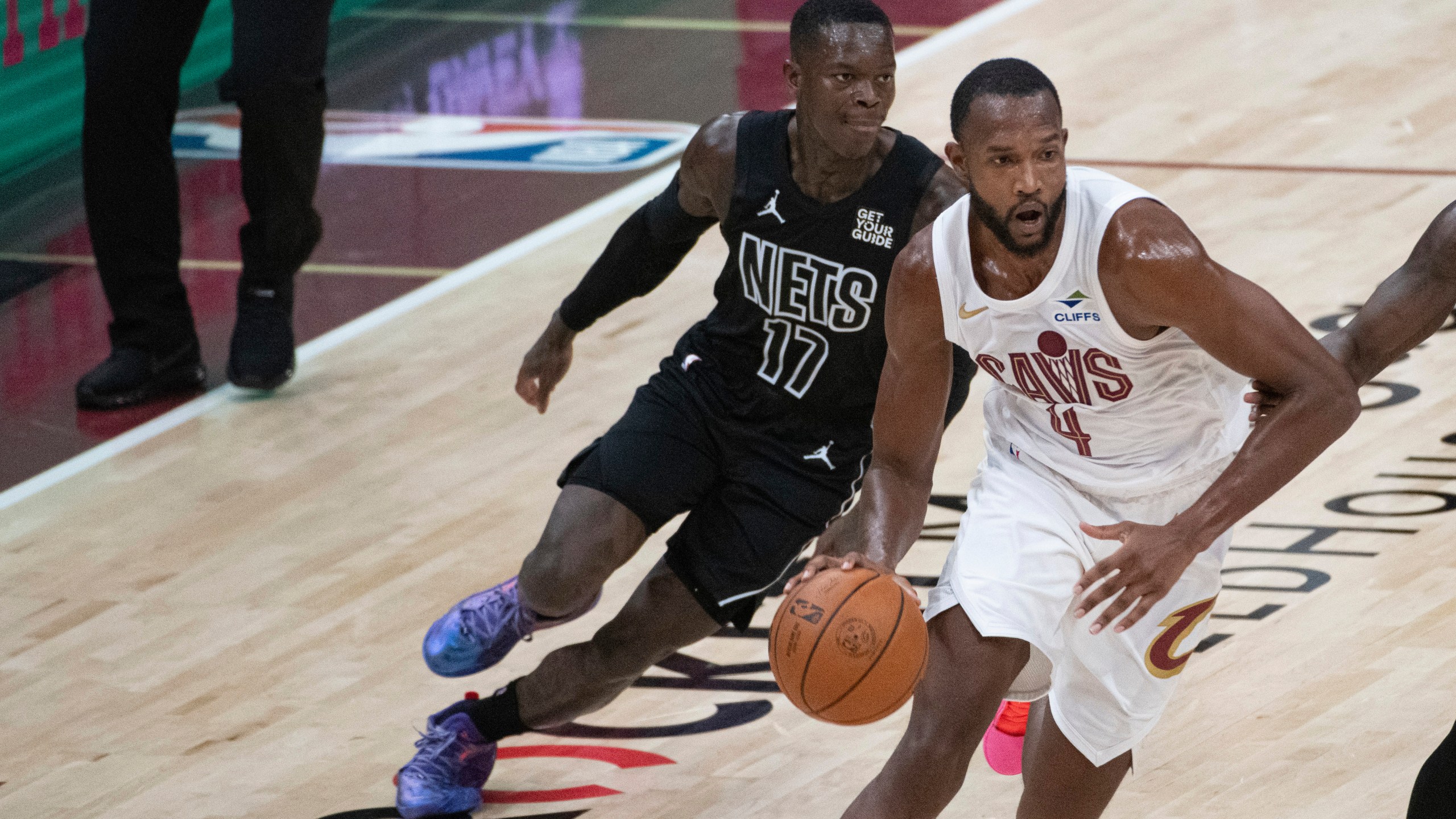 Cleveland Cavaliers' Evan Mobley (4) drives past Brooklyn Nets' Dennis Schroder (17) during the first half of an NBA basketball game in Cleveland, Saturday, Nov. 9, 2024. (AP Photo/Phil Long)