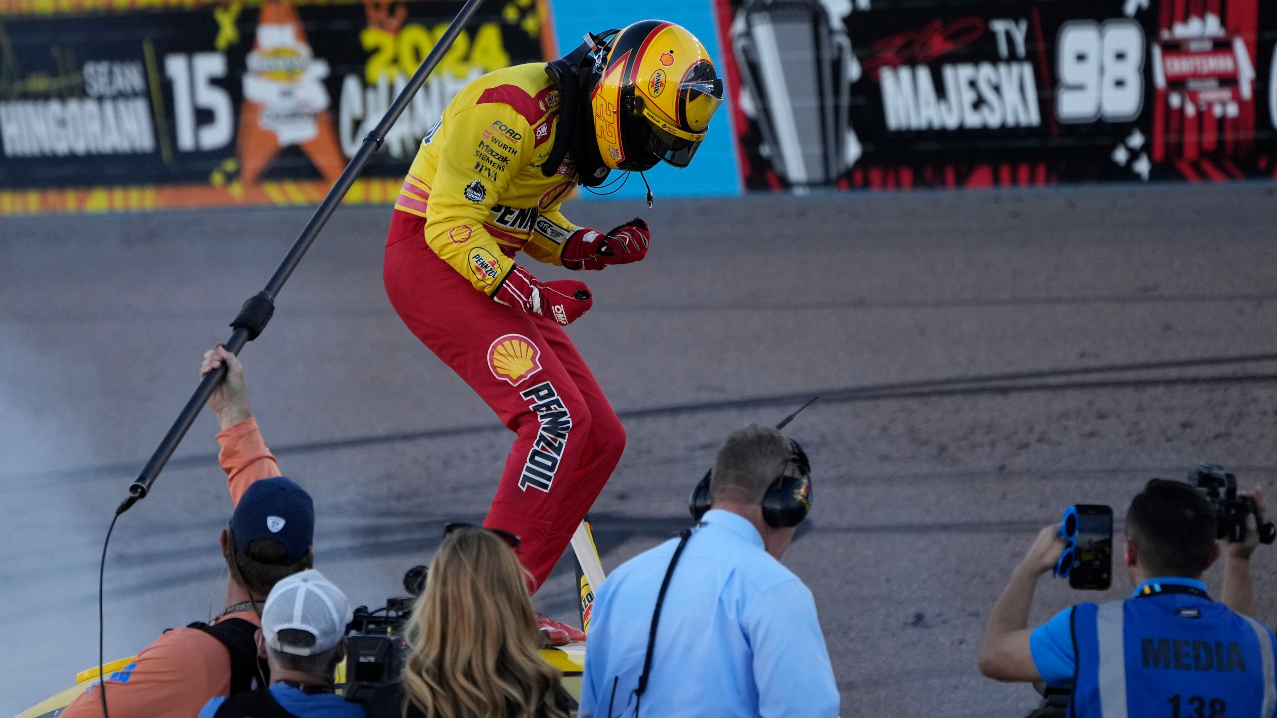 Joey Logano celebrates after winning a NASCAR Cup Series Championship auto race for the championship at Phoenix Raceway, Sunday, Nov. 10, 2024, in Avondale, Ariz. (AP Photo/John Locher)