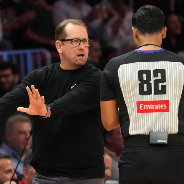 Philadelphia 76ers head coach Nick Nurse, left, talks with official Suyash Mehta (82) during the second half of an NBA basketball game against the Miami Heat, Monday, Nov. 18, 2024, in Miami. (AP Photo/Lynne Sladky)