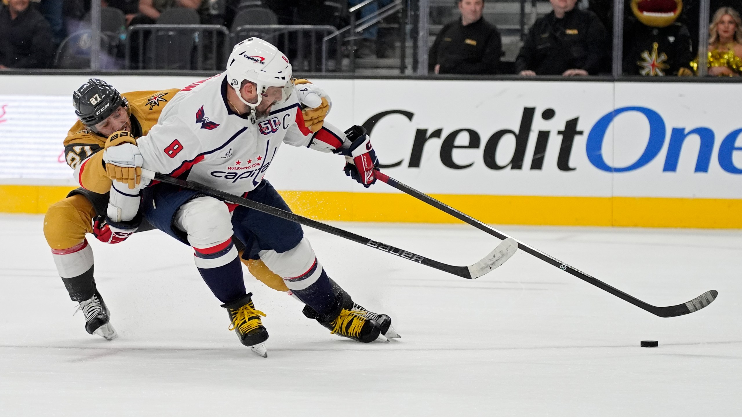 Washington Capitals left wing Alex Ovechkin (8) scores an open net goal past Vegas Golden Knights defenseman Shea Theodore (27) for a hat trick during the third period of an NHL hockey game Sunday, Nov. 17, 2024, in Las Vegas. (AP Photo/John Locher)