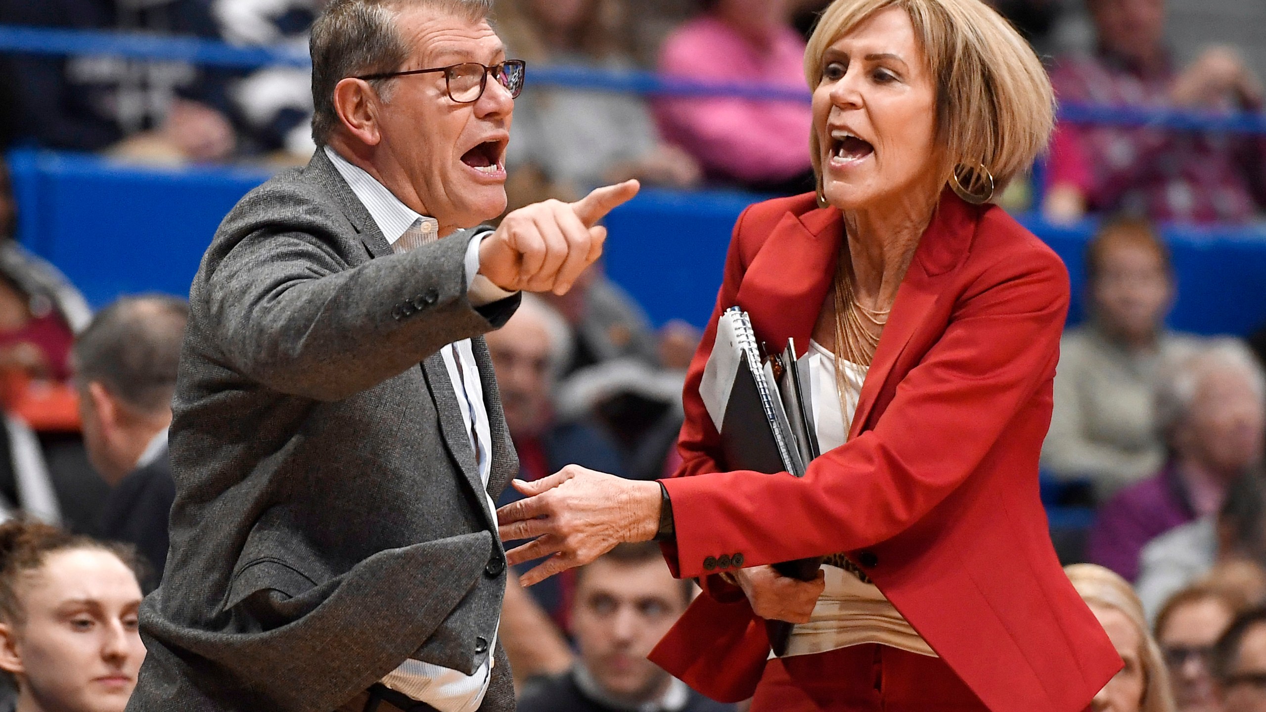 FILE - UConn coach Geno Auriemma, left, is held back by associate head coach Chris Dailey, right, as he argues a call during the first half of the an NCAA college basketball game against Baylor, Thursday, Jan. 9, 2020, in Hartford, Conn. (AP Photo/Jessica Hill, File)