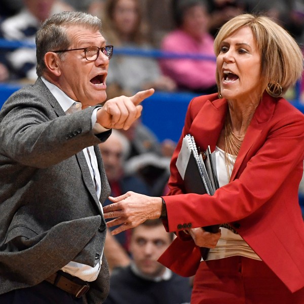 FILE - UConn coach Geno Auriemma, left, is held back by associate head coach Chris Dailey, right, as he argues a call during the first half of the an NCAA college basketball game against Baylor, Thursday, Jan. 9, 2020, in Hartford, Conn. (AP Photo/Jessica Hill, File)