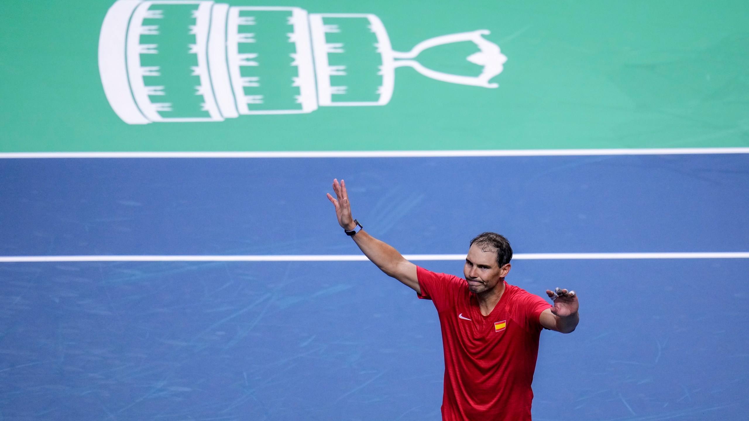 Spain's tennis player Rafael Nadal waves to the crowd after losing against Netherlands' Botic Van De Zandschulp during a Davis Cup quarterfinal match at Martin Carpena Sports Hall in Malaga, southern Spain, on Tuesday, Nov. 19, 2024. (AP Photo/Manu Fernandez)