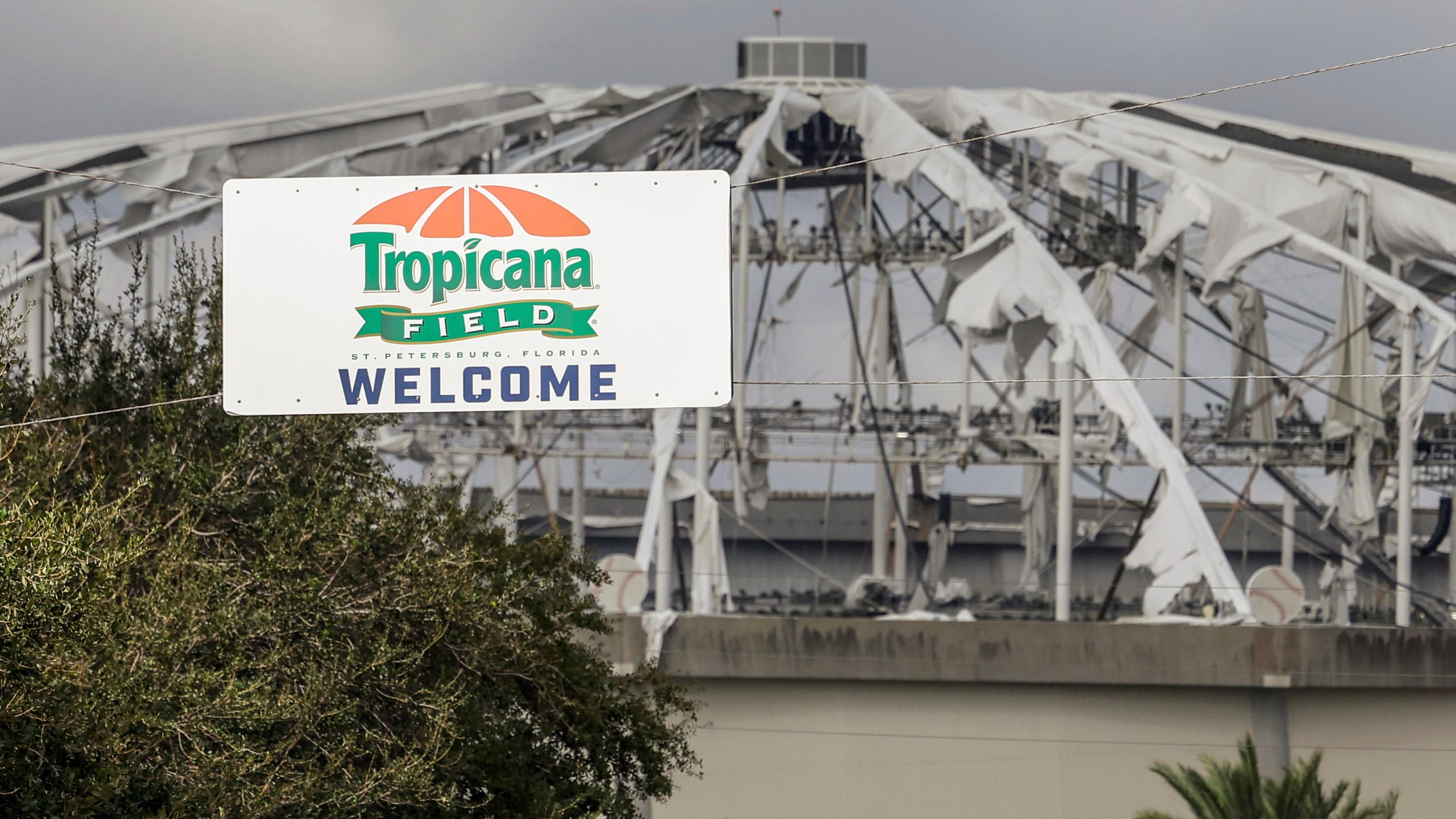 FILE - Signage at the entrance to the parking lot of Tropicana Field where the roof was torn off during Hurricane Milton on Thursday, Oct. 10, 2024, in St. Petersburg, Fla. (AP Photo/Mike Carlson, File)