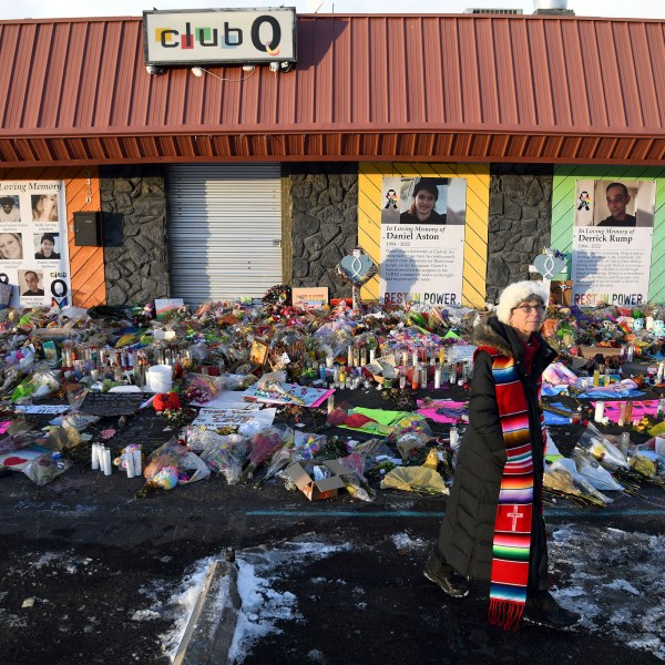 FILE - Rev. Paula Stecker of the Christ the King Lutheran Church stands in front of a memorial set up outside Club Q following a mass shooting at the gay nightclub in Colorado Springs, Colo., Nov. 29, 2022. (AP Photo/Thomas Peipert, File)