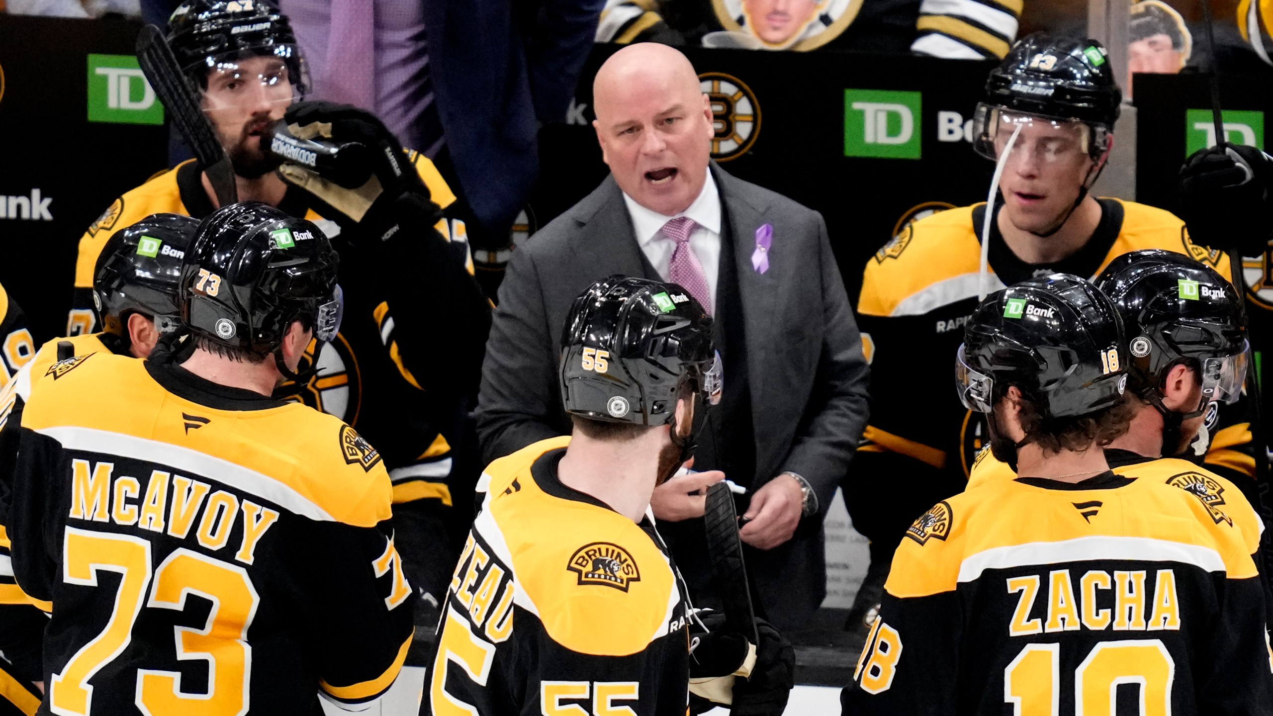 Boston Bruins head coach Jim Montgomery talks with his players during a time out during the third period of an NHL hockey game against the Philadelphia Flyers, Tuesday, Oct. 29, 2024, in Boston. (AP Photo/Charles Krupa)