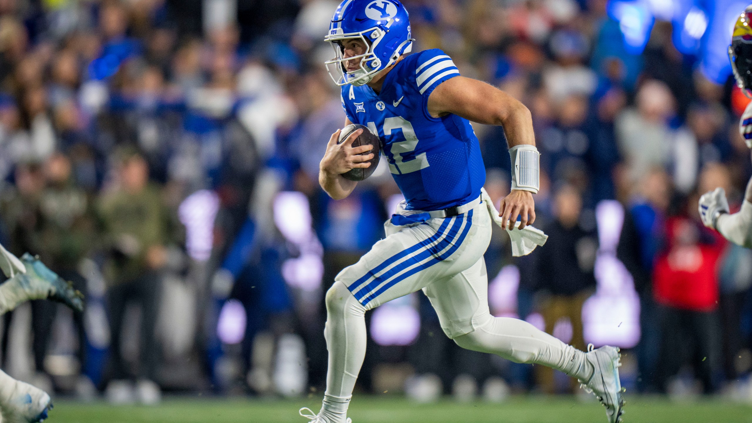 BYU quarterback Jake Retzlaff runs on a quarterback keeper, during the first half of an NCAA college football game Saturday, Nov. 16, 2024, in Provo. (AP Photo/Rick Egan)