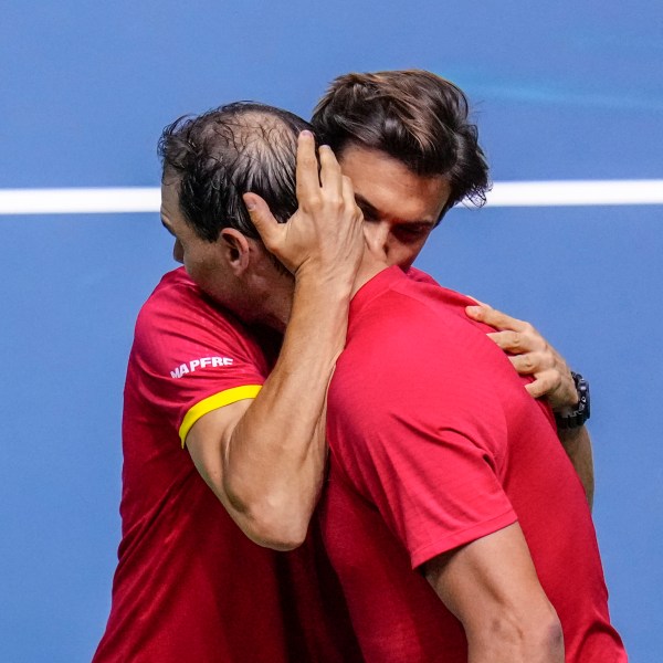 Spain's tennis player Rafael Nadal embraces David Ferrer, captain of Team Spain, after losing against Netherlands' Botic Van De Zandschulp during a Davis Cup quarterfinal match at Martin Carpena Sports Hall in Malaga, southern Spain, on Tuesday, Nov. 19, 2024. (AP Photo/Manu Fernandez)