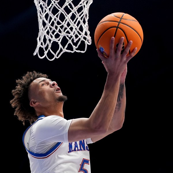 Kansas guard Zeke Mayo shoots during the first half of an NCAA college basketball game against UNC Wilmington Tuesday, Nov. 19, 2024, in Lawrence, Kan. (AP Photo/Charlie Riedel)