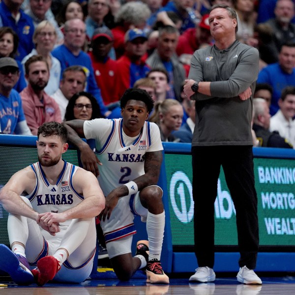 Kansas head coach Bill Self watches with center Hunter Dickinson, left, and guard AJ Storr (2) during the second half of an NCAA college basketball game against UNC Wilmington, Tuesday, Nov. 19, 2024, in Lawrence, Kan. (AP Photo/Charlie Riedel)