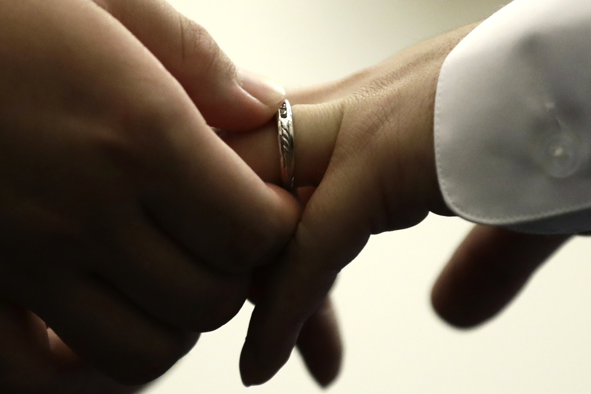 FILE - A couple exchanges wedding bands at City Hall in Philadelphia, Oct. 11, 2018. (AP Photo/Matt Rourke, File)