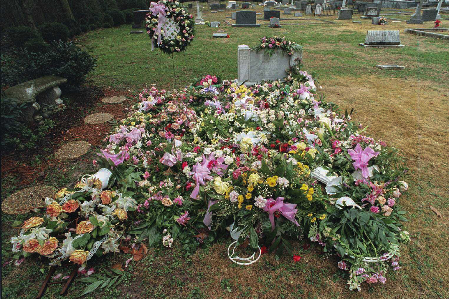 FILE - The gravesite of JonBenet Ramsey is shown covered with numerous flowers, Jan. 8, 1997, at St. James Episcopal Cemetery in Marietta, Ga. (Andy Sharp/Atlanta Journal-Constitution via AP)