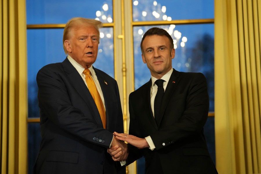 French President Emmanuel Macron, right, shakes hands with President-elect Donald Trump at the Elysee Palace, Saturday, Dec. 7, 2024 in Paris. (AP Photo/Aurelien Morissard)