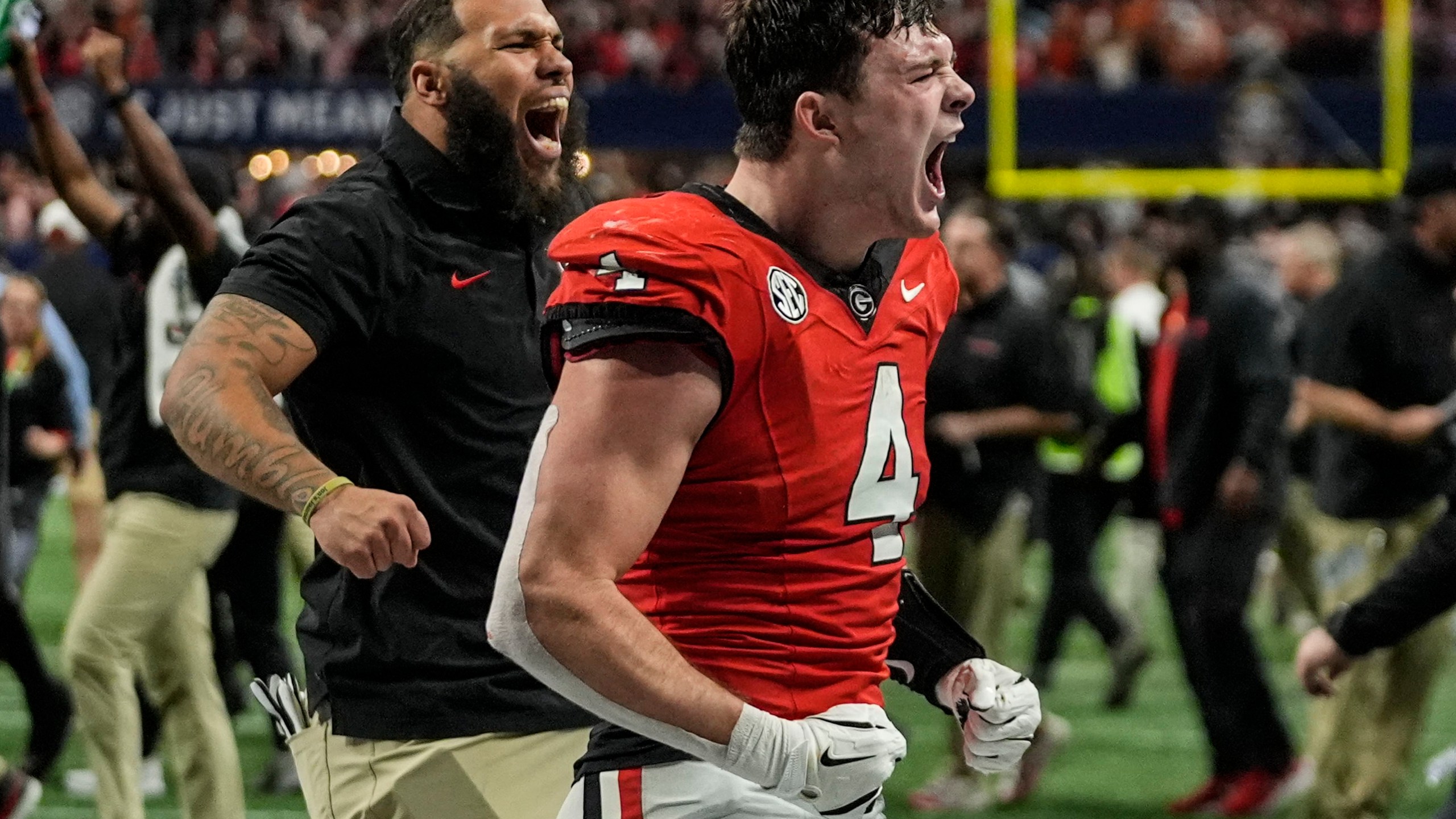 Georgia tight end Oscar Delp (4) celebrates a win over Texas after overtime in the Southeastern Conference championship NCAA college football game, Saturday, Dec. 7, 2024, in Atlanta. (AP Photo/John Bazemore)