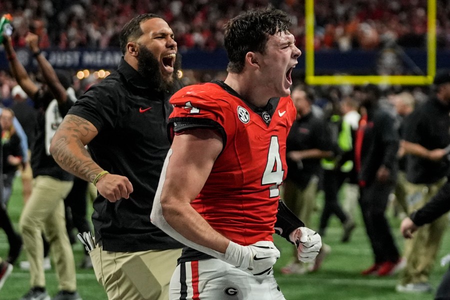 Georgia tight end Oscar Delp (4) celebrates a win over Texas after overtime in the Southeastern Conference championship NCAA college football game, Saturday, Dec. 7, 2024, in Atlanta. (AP Photo/John Bazemore)