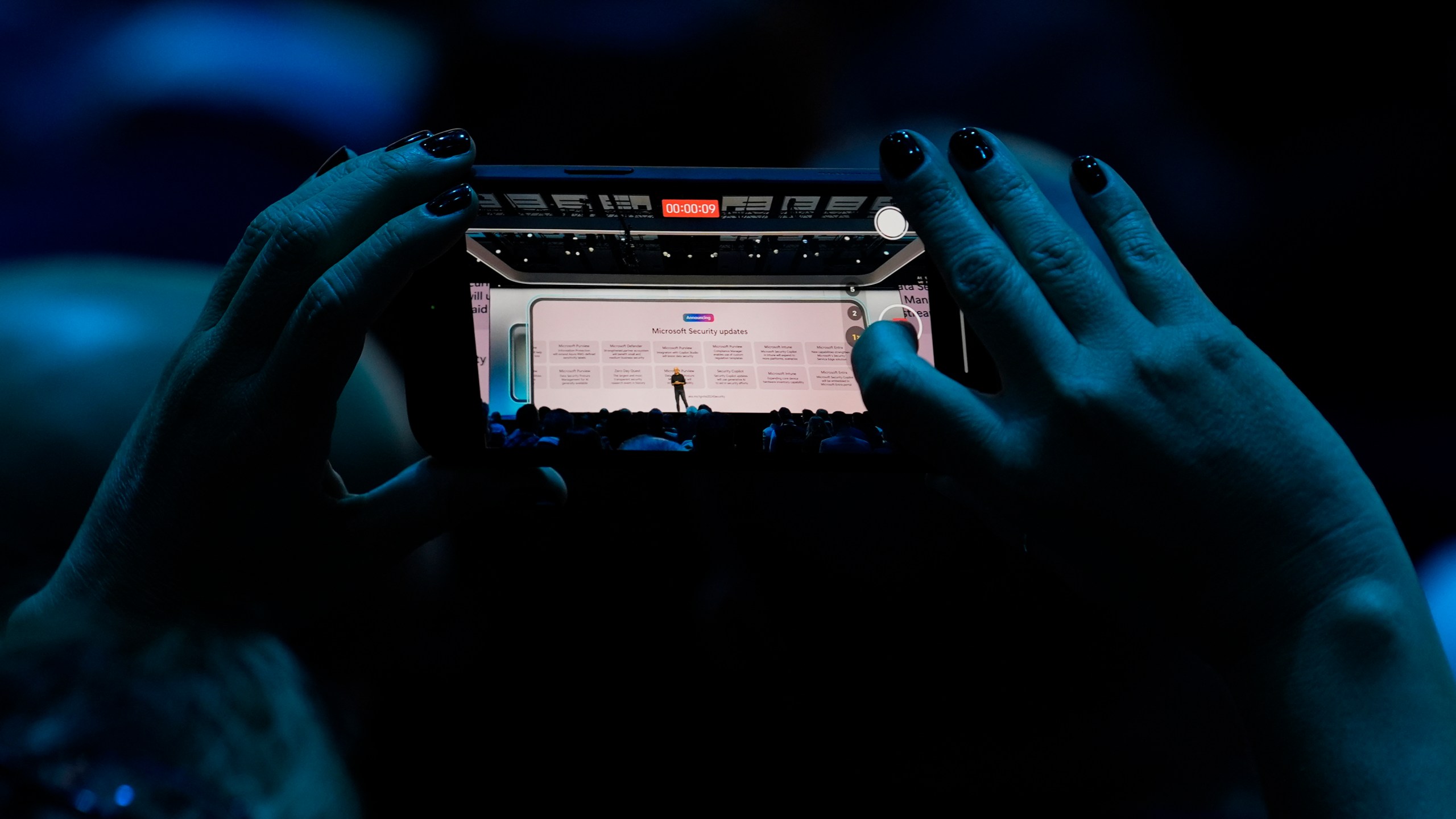 FILE - An attendee at the Microsoft Ignite conference records an address on Nov. 19, 2024, in Chicago. (AP Photo/Charles Rex Arbogast, File)