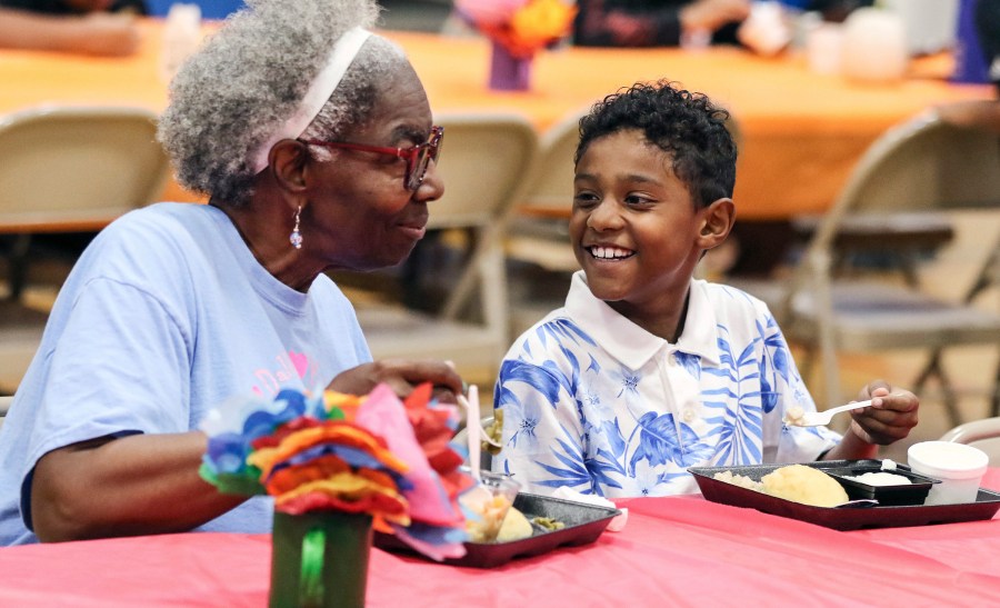 FILE - Third-grader Dallin Curry, 8, smiles as he talks with his grandmother, Mary Durr, Sept. 6, 2024, during a Grandparents Day celebration in the lunchroom at Burns Elementary School in Owensboro, Ky. (Alan Warren/The Messenger-Inquirer via AP, File)