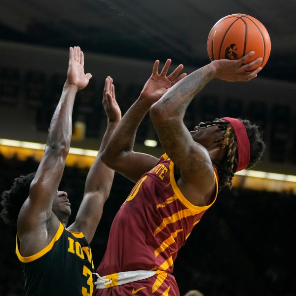 Iowa State guard Keshon Gilbert shoots over Iowa guard Drew Thelwell, left, during the first half of an NCAA college basketball game, Thursday, Dec. 12, 2024, in Iowa City, Iowa. (AP Photo/Charlie Neibergall)