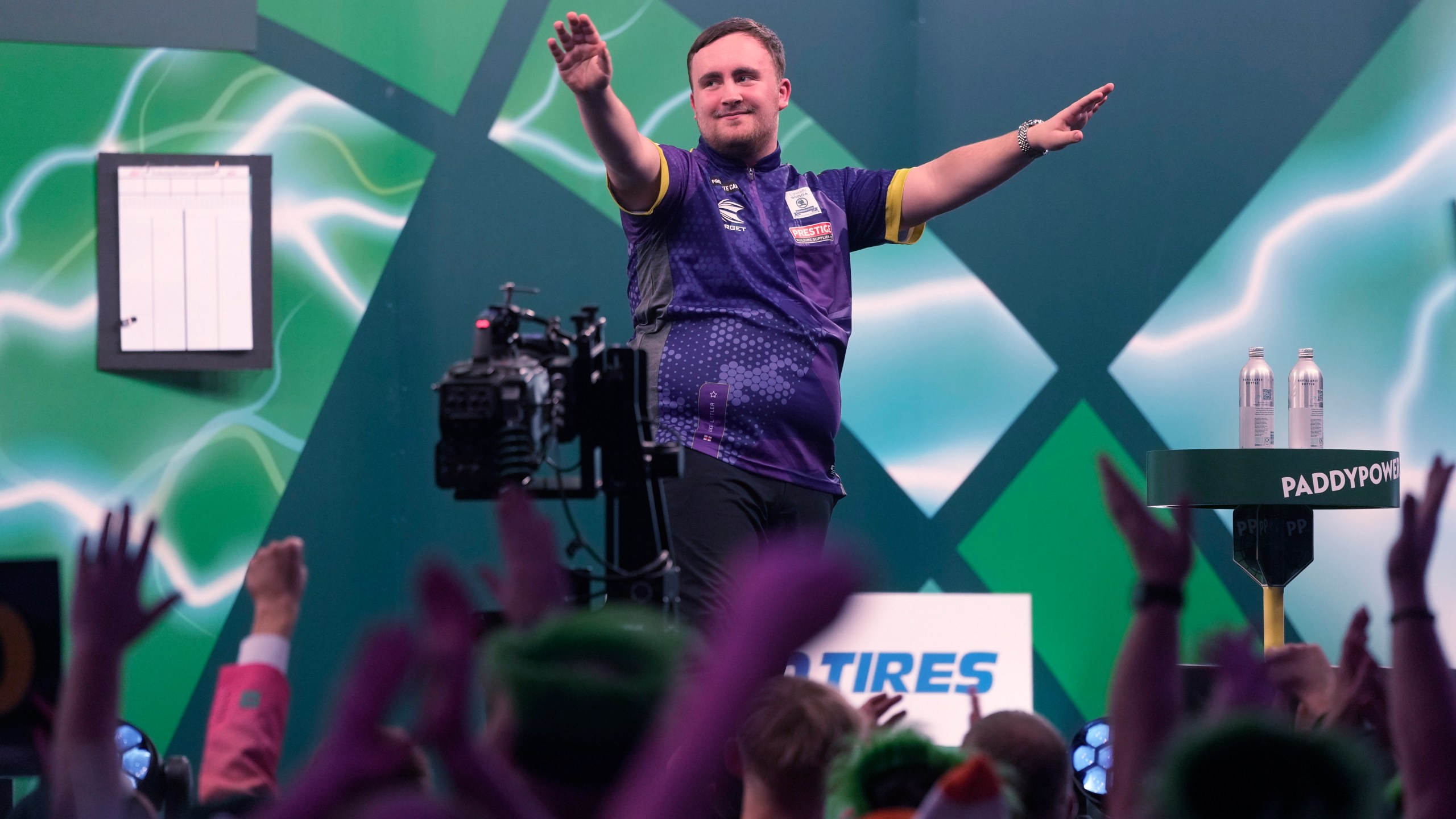 FILE - Luke Littler of England, celebrates after winning the quarterfinal match against Brendan Dolan of Northern Ireland at the World Darts Championship, in London, Monday, Jan. 1, 2024. (AP Photo/Kin Cheung, File)