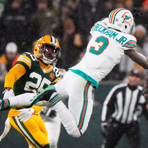 Green Bay Packers cornerback Keisean Nixon (25) breaks up a pass intended for Miami Dolphins wide receiver Odell Beckham Jr. (3) during the second half of an NFL football game Thursday, Nov. 28, 2024, in Green Bay, Wis. (AP Photo/Morry Gash)