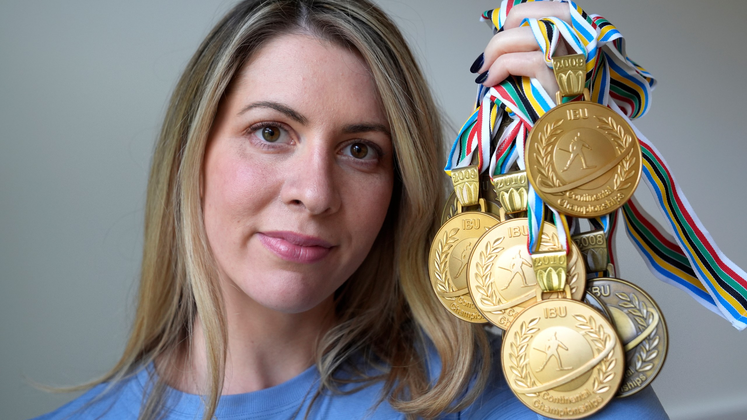 Grace Boutot, who won a silver medal in the Youth World Championships in 2009, displays a few of her medals from competitions, Oct. 17, 2024, at her home in Boston. (AP Photo/Steven Senne)