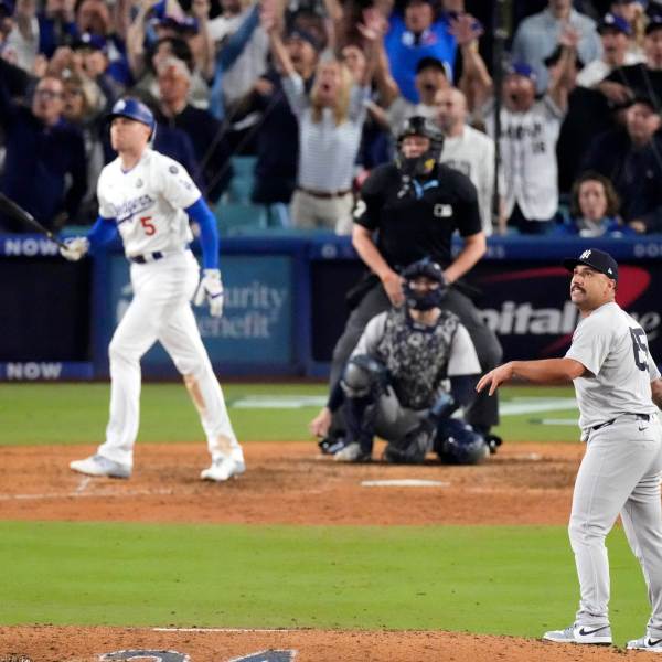 FILE - New York Yankees relief pitcher Nestor Cortes, right, watches as Los Angeles Dodgers' Freddie Freeman, left, hits a walk-off grand slam home run during the 10th inning in Game 1 of the baseball World Series, Friday, Oct. 25, 2024, in Los Angeles. (AP Photo/Mark J. Terrill, File)