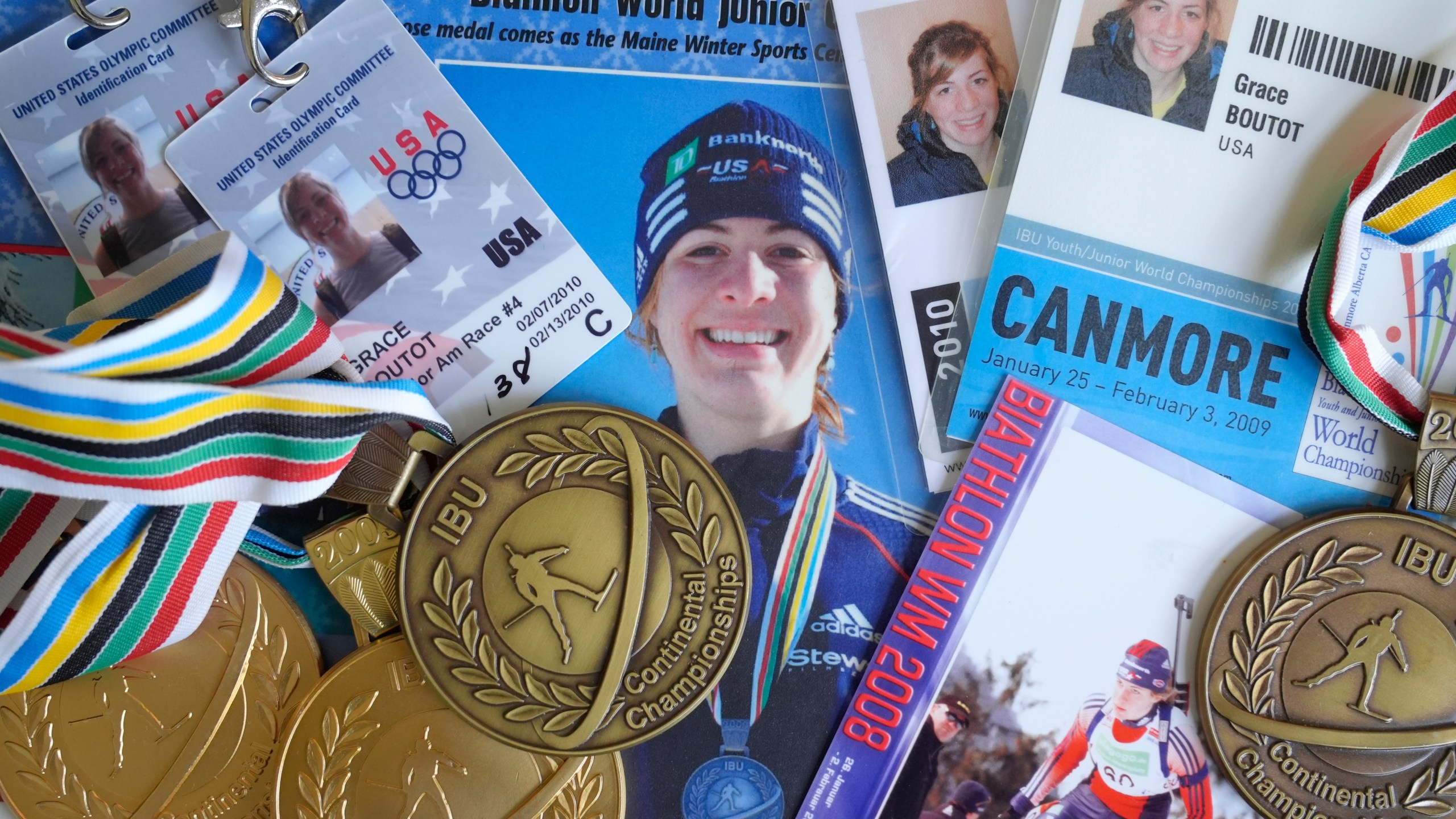 Biathlon competition medals, credentials, and media clippings belonging to Grace Boutot, silver medalist in Youth World Championships in 2009, are displayed for a photograph at her home, Oct. 17, 2024, in Boston. (AP Photo/Steven Senne)