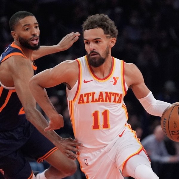 Atlanta Hawks' Trae Young (11) drives past New York Knicks' Mikal Bridges during the first half of an Emirates NBA Cup basketball game Wednesday, Dec. 11, 2024, in New York. (AP Photo/Frank Franklin II)