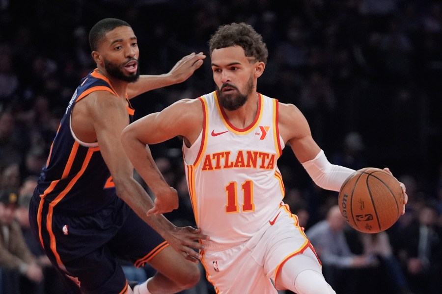 Atlanta Hawks' Trae Young (11) drives past New York Knicks' Mikal Bridges during the first half of an Emirates NBA Cup basketball game Wednesday, Dec. 11, 2024, in New York. (AP Photo/Frank Franklin II)