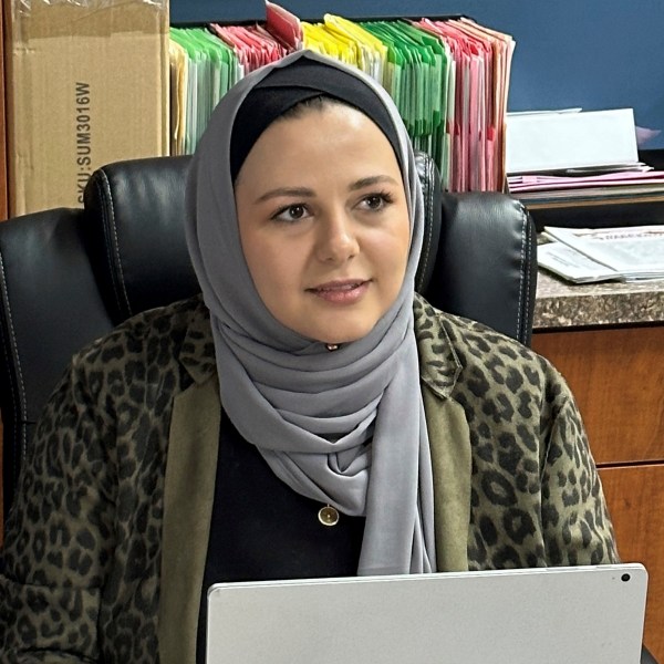 Rama Alhoussaini sits at her desk in Dearborn Heights, Mich., Tuesday, Dec. 10, 2024. (AP Photo/Corey Williams)