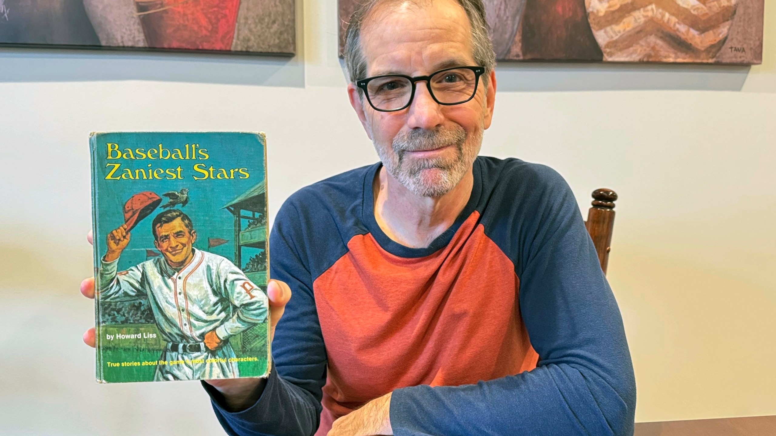 Chuck Hildebrandt of Chicago holds the book "Baseball's Zaniest Stars" on Dec. 10, 2024, which was due back at the Warren, Mich., library on Dec. 4, 1974. (Terrie Wendricks via AP)