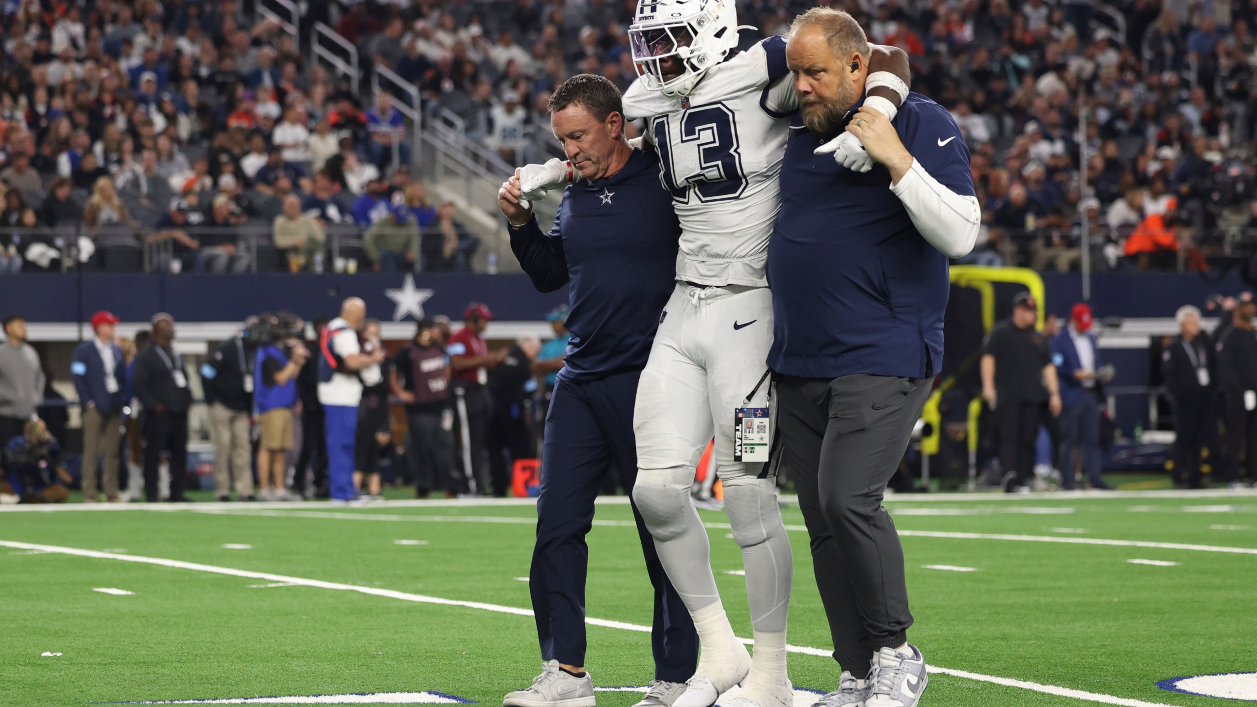 Dallas Cowboys linebacker DeMarvion Overshown is helped off the field after being injured during the second half of an NFL football game against the Cincinnati Bengals, Monday, Dec. 9, 2024, in Arlington, Texas. (AP Photo/Gareth Patterson)