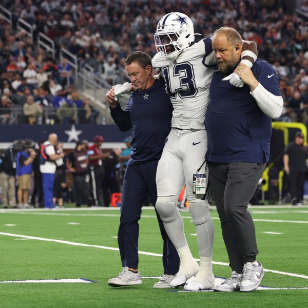 Dallas Cowboys linebacker DeMarvion Overshown is helped off the field after being injured during the second half of an NFL football game against the Cincinnati Bengals, Monday, Dec. 9, 2024, in Arlington, Texas. (AP Photo/Gareth Patterson)