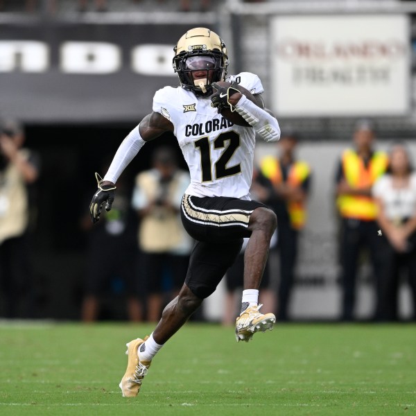 FILE - Colorado wide receiver Travis Hunter (12) runs after catching a pass during the first half of an NCAA college football game against Central Florida, Saturday, Sept. 28, 2024, in Orlando, Fla. (AP Photo/Phelan M. Ebenhack, File)