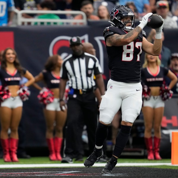 Houston Texans tight end Cade Stover (87) catches a pass in the end zone for a touchdown during the first half of an NFL football game against the Tennessee Titans, Sunday, Nov. 24, 2024, in Houston. (AP Photo/Ashley Landis)